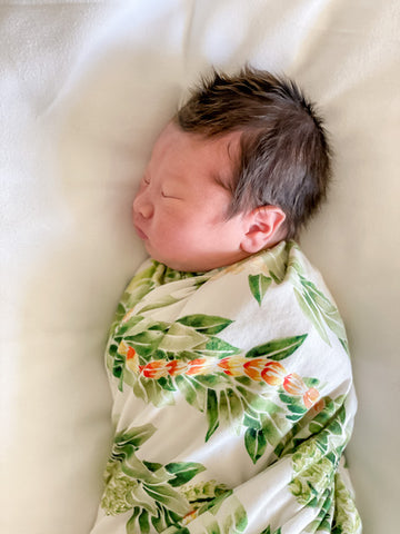 newborn baby wrapped in lei maile bamboo swaddle blanket