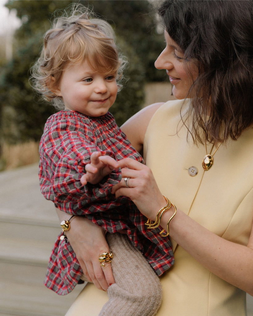 misho-jewellery-penny-goldstone-holding-a-child