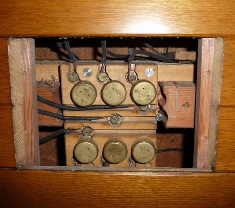 Craigdarroch Castle's original 1890's fuse panel showing six fuses and wires