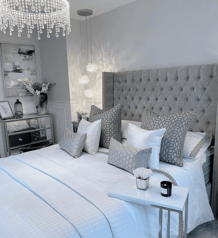 An upholstered grey headboard forms the centerpiece of this stunning bedroom, which features Hampton and Astley long-staple cotton sateen bedding in pure white