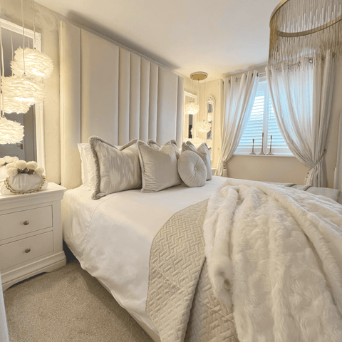 Feather bedside lights, a chandelier and plump cushions all add to the luxe look of this bedroom, plus a set of silky-smooth Hampton and Astley Egyptian cotton sateen bedding.