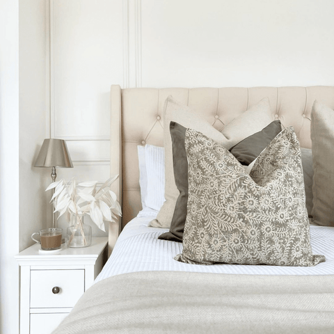 Sage green, botanical print cushions contrast beautifully with pure white Egyptian cotton bedding.