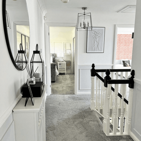 Upstairs, black accents add visual interest to the landing.