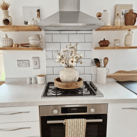 Wooden shelves and metro tiles add a country kitchen feel.