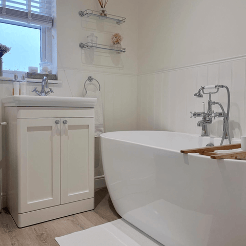 The bathroom is a seamless blend of the classic and the modern, with a sleek freestanding tub and traditional style fixings.