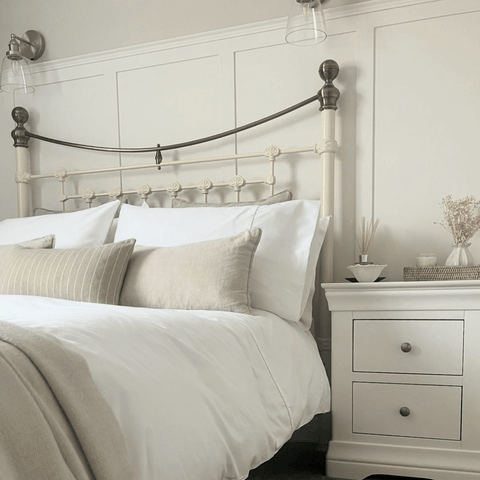 A wrought iron bed frame adds a classic edge and looks fabulous with a set of pure white Hampton and Astley Egyptian cotton sateen bedding.