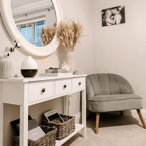 A console table complete with a Hampton and Astley Sandalwood and Cedar scented candle and a fabulous armchair makes a comfy corner to sit back and relax