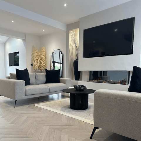 Herringbone flooring complements the geometric design elements in the open plan living space.