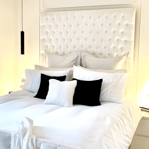 Accents of black add elegance to simple white décor and a set of pure white Hampton and Astley Egyptian cotton bedding.