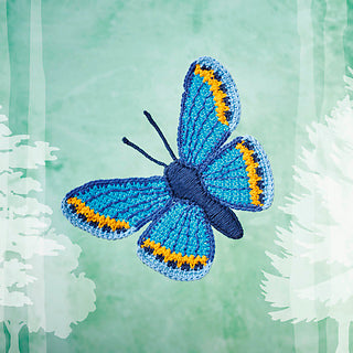 Crochet butterfly with dark blue body, blue wings and yellow details