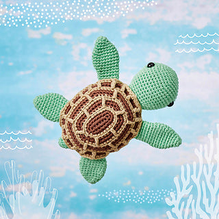 Crochet turtle with pale green limbs and head and a brown shell