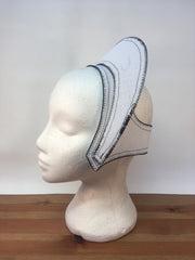 Side view of a tudor french hood hat and the inside layer of buckram on a display mannequin head