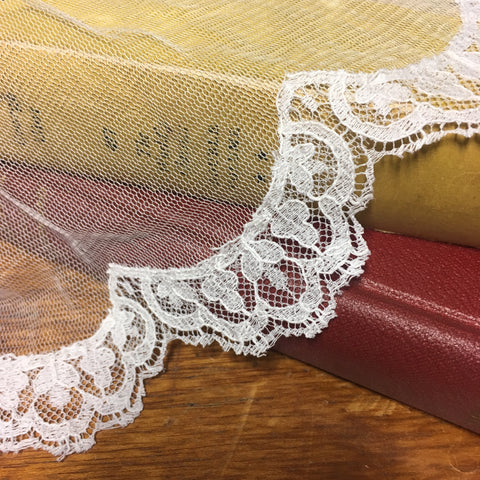 Pale ivory scalloped lace trim available along the edge of a veil