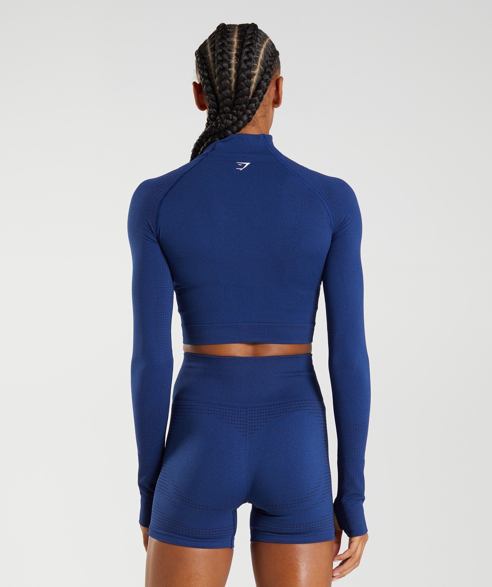 The Gymshark Flex Long Sleeve Crop Top, Steel Blue Marl/ Evening Navy Blue.  With figure enhancing contourin…