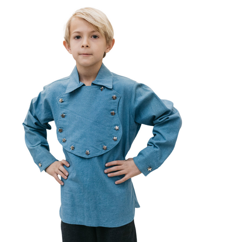 blonde haired light skinned boy of about 9 years in blue frontier shirt with hands on hips