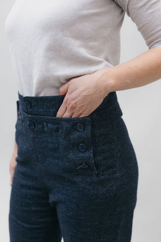 close up of front with hand in coin pocket on navy sailor pants