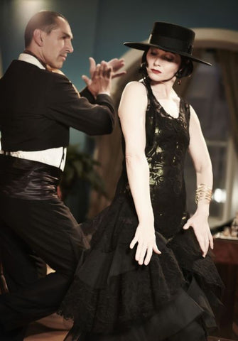 Miss Fisher dancing in black sparkly dress with a man in a black tux.