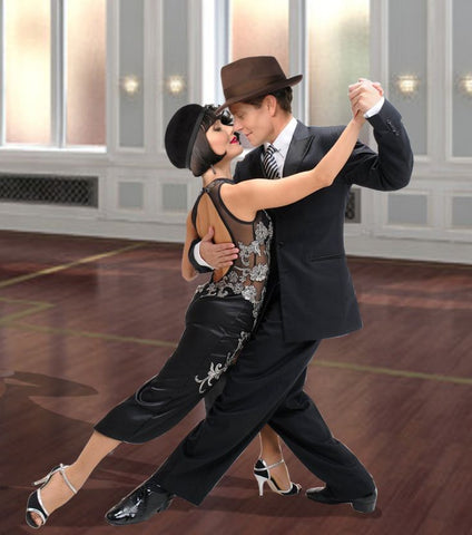 Woman and man dancing tango wearing a black and silver dress and a black suit with a hat.