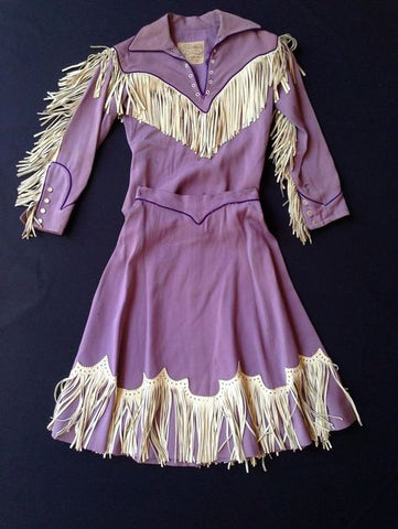 purple cowgirl outfit with white applique and fringe.