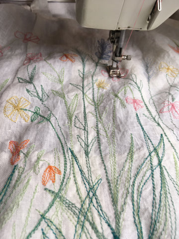 Photo upclose of using the traced design to stitch the 213 pinafore Flower design