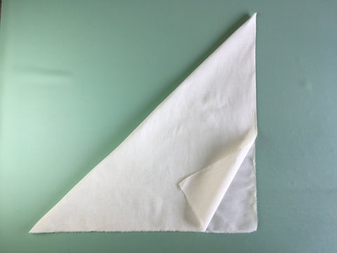 Photo of fabric square folded diagonally to create the true bias