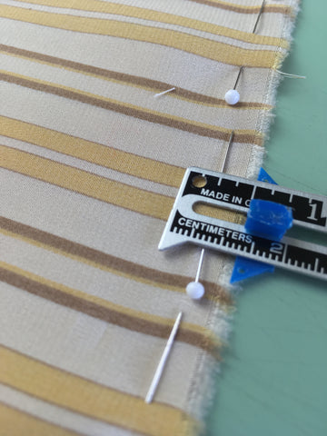 Photo of silk pinned within the seam allowance