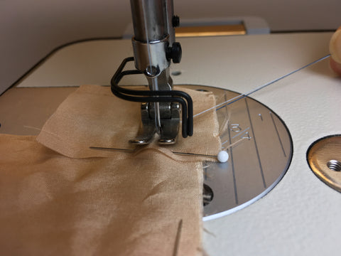 Photo showing holding of thread using small square of self fabric