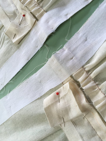 Up-close photo of waistband facing pinned out of the way to add interfacing and zipper