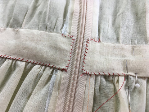 Photo of hand whip stitching waistband facing