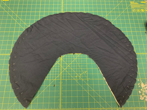 Right sides together of all three layers of collar D with navy blue voile facing up,  pinned along outer edge on a green cutting mat.