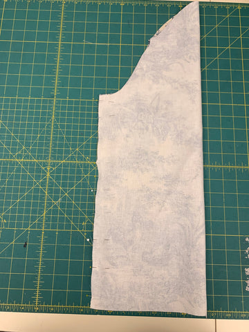 Pinned sleeve right sides together on a green cutting mat.