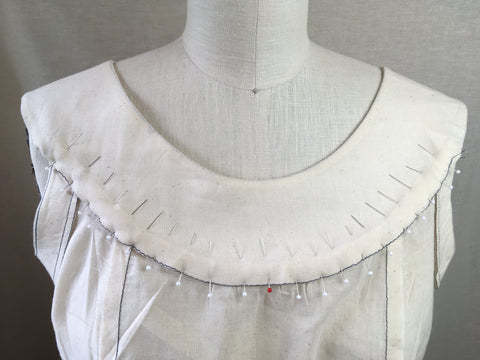 Photo of Folkwear 160 Hawaiian Mu'umu'u front yoke facing pinned in place using stitching line as a guide