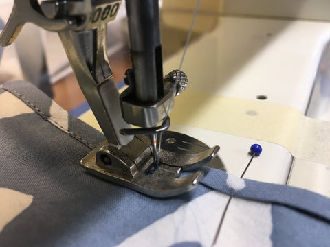 Photo up close of stitching binding on machine