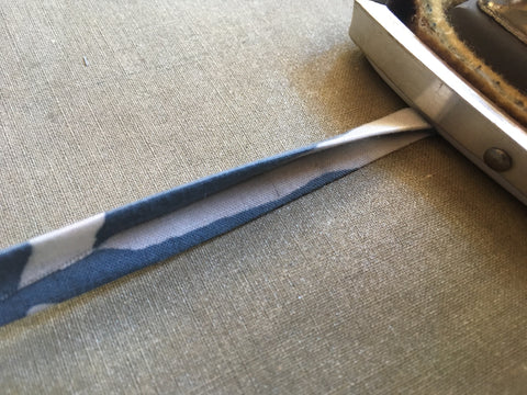 Photo of ironing edge of binding for button-loop