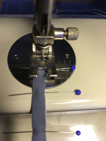 Photo of button-loop binding edge stitched on machine