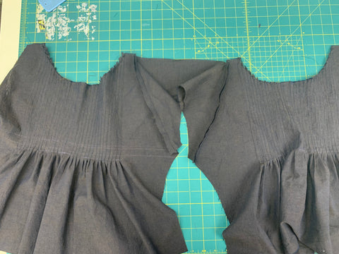 Sleeve C attached to bodice front and back on a green cutting mat.