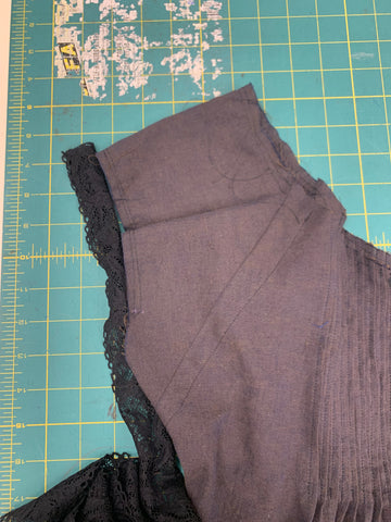 Black Lace placed on the edge of the sleeve on a green cutting mat