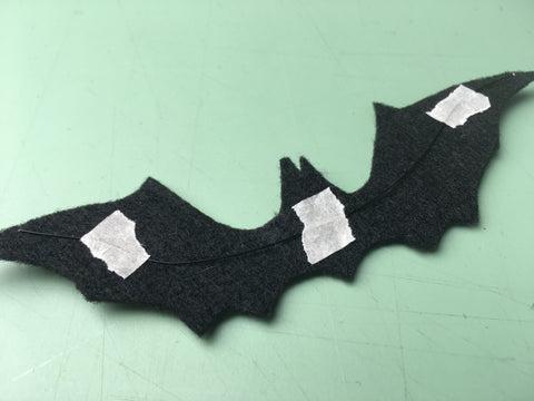 Photo of using masking tape to hols wire to felt bat
