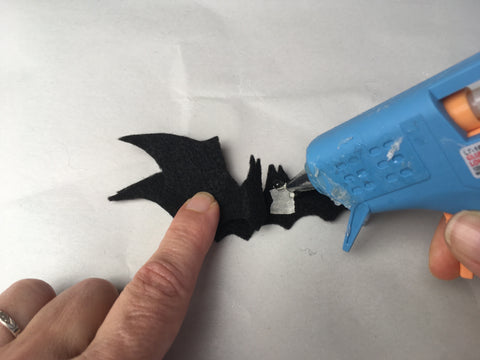 Phot of using hot glue to secure center of bat shapes together