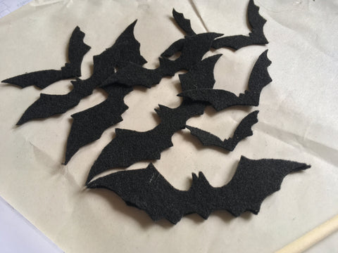 Photo of multiple felt bats to be used on Halloween cape
