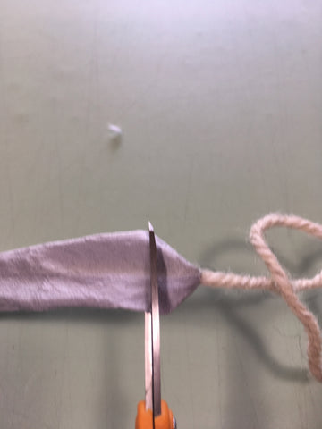 Trimming the yarn from the tube.