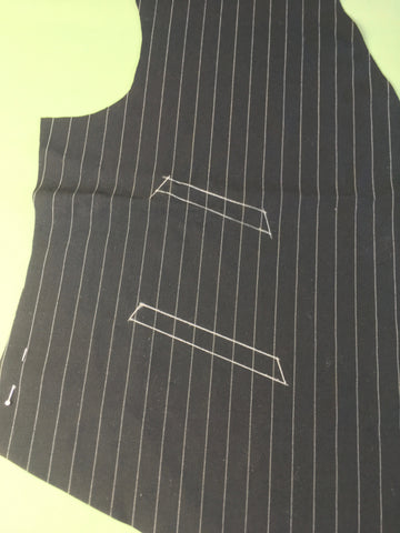 Photo of vest front with pocket opening drawn in chalk