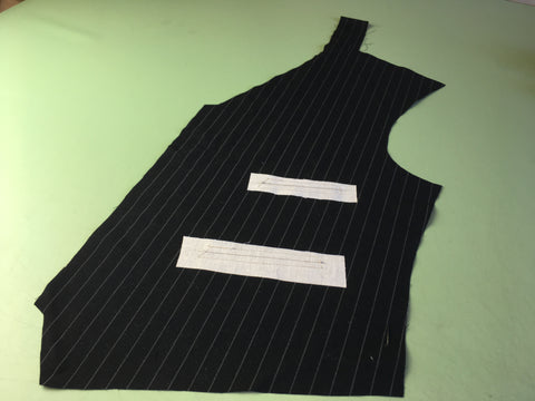 Photo of fusible interfacing added and covering pocket opening on wrong side of vest fabric