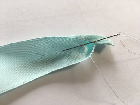 Making a stich through the center point of the Heart Ruching