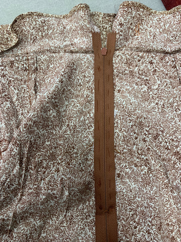 hand basted brown zipper on the center back of beige and brown floral silk fabric.