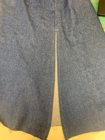 stitched slit in the center back of the long denim sailor skirt.