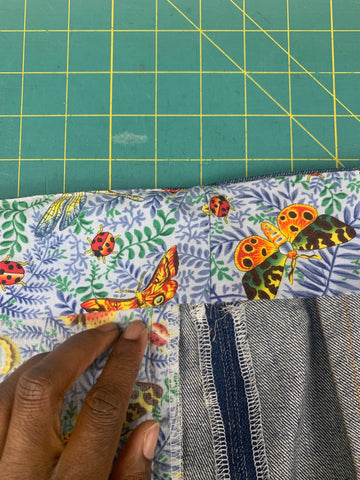 right side of waistband curtain in botanical blue and orange print in pressed to the inside over the outer waistband.