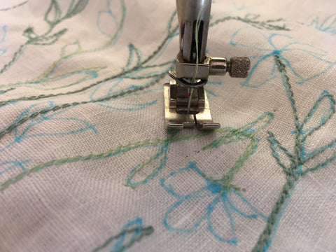 Photo upclose of using the traced design to stitch the 213 pinafore design