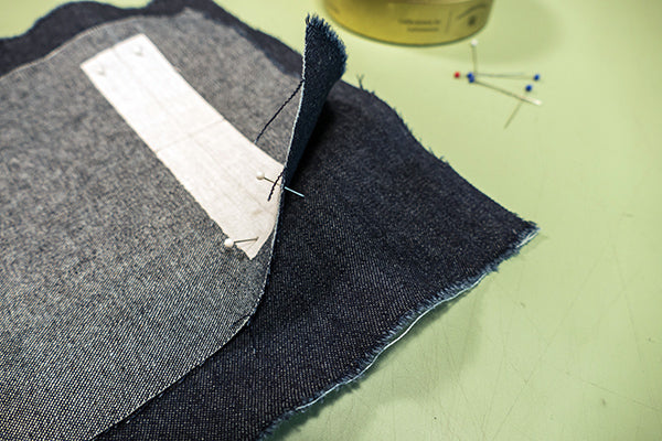 Using pins to align the corner dots on the Garment fabric and the pocket welt.