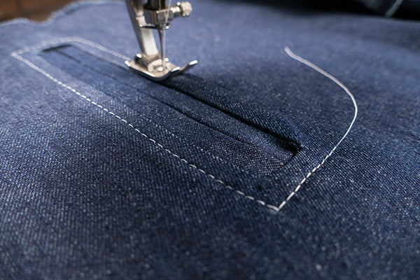 Top stitching around the pocket opening creates a nice detail and secures the welts in place.